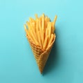 Fried potatoes in waffle cones on blue background. Hot salty french fries with tomato sauce. Fast food, junk food, diet