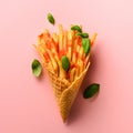 Fried potatoes in waffle cones on pink background. Hot salty french fries with sauce, basil leaves. Fast food, junk food