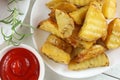 Fried potatoes on a white plate. Potato dish in a restaurant