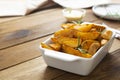 Fried potatos chips in white dish. Homemade roasted potatoes chips. Wooden, rustic background