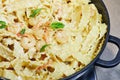 Fried prawns with Italian pasta called mafaldine, Parmesan cheese and herbs in a pan Royalty Free Stock Photo