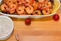 fried prawns on a plate with white sauce on a wooden background Royalty Free Stock Photo