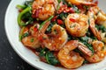 Fried prawns or shrimps with spinach, chili and garlic in white plate Royalty Free Stock Photo