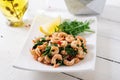 Fried prawns or shrimps with spinach, chili and garlic in white plate. Royalty Free Stock Photo