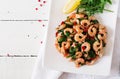 Fried prawns or shrimps with spinach, chili and garlic in white plate. Royalty Free Stock Photo
