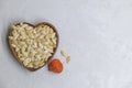 Fried pumpkin seeds lies in heart shaped bowl