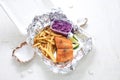 Fried rainbow trout fillet served with potato fries and salad, in takeaway boxes. Fish and chips, lunch set.