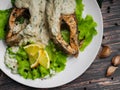 Fried red fish in cream sauce with lemon. Pieces of trout
