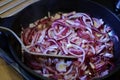 Fried red onion in oil in frying pan Royalty Free Stock Photo