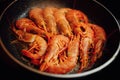 Fried red shrimps with hot oil on pan Royalty Free Stock Photo