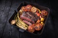 Fried rib eye steak in a cut in a cast iron pan with vegetables. Royalty Free Stock Photo