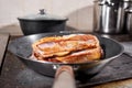 Fried ribs of lamb. Cooking with fire in frying pan. Professional chef in a kitchen of restaurant cooking. Man frying Royalty Free Stock Photo