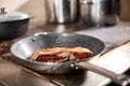 Fried ribs of lamb. Cooking with fire in frying pan. Professional chef in a kitchen of restaurant cooking. Man frying Royalty Free Stock Photo