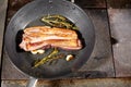 Fried ribs of lamb. Cooking with fire in frying pan. Professional chef in a kitchen of restaurant cooking. Man frying Royalty Free Stock Photo