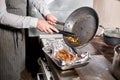 Fried ribs of lamb. Cooking with fire in frying pan. Professional chef in a kitchen of restaurant cooking. Man frying Royalty Free Stock Photo