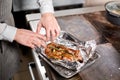 Fried ribs of lamb. Cooking with fire in frying pan. Professional chef in a kitchen of restaurant cooking. Man frying Royalty Free Stock Photo