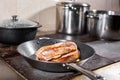 Fried ribs of lamb. Cooking with fire in frying pan. Professional chef in a kitchen of restaurant cooking. Man frying Royalty Free Stock Photo