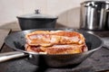 Fried ribs of lamb. Cooking with fire in frying pan. Professional chef in a kitchen of restaurant cooking. Man frying Royalty Free Stock Photo