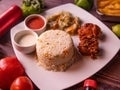 fried rice with fried chicken, drink, with raita, sauce, salad and drink isolated on wooden background top view of korean food