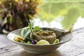 Fried rice with chili spicy with fish and vegetables in white plate on wooden table. Background rivers and trees Royalty Free Stock Photo