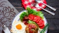 Fried rice with chinese sausage served in a white plate with fried egg, tomato and lettuce Royalty Free Stock Photo