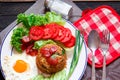 Fried rice with chinese sausage served in a white plate with fried egg, tomato and lettuce Royalty Free Stock Photo
