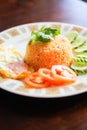 Fried Rice with Fried Egg Put on the wooden table and the tomatoes, cucumbers, garlic, shallots. Royalty Free Stock Photo