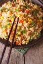 Fried rice with eggs, corn and spices and chopsticks