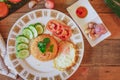 Fried Rice with Fried Egg Put on the wooden table and the tomatoes, cucumbers, garlic, shallots. Royalty Free Stock Photo