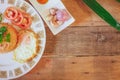 Fried Rice with Fried Egg Put on the wooden table and the tomatoes, cucumbers, garlic, shallots. Royalty Free Stock Photo