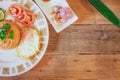 Fried Rice with Fried Egg Put on the wooden table and the tomatoes, cucumbers, garlic, shallots. Royalty Free Stock Photo