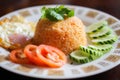 Fried Rice with Fried Egg Put on the wooden table and the tomatoes, cucumbers, garlic, shallots. Royalty Free Stock Photo