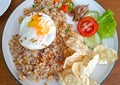 Indonesian Nasi Goreng or Friend Rice with emping crackers and ied egg.