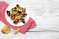 Fried rice with seafood mussels, shrimps and basil in a plate with wineglass, towel and toasted baguette on white cracked wooden t Royalty Free Stock Photo