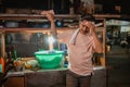 fried rice seller wiping his sweat