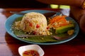 Fried rice shrimp egg with seafood cucumber lime on plate on the table outdoors thai style food. Royalty Free Stock Photo