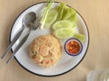 Fried rice with shrimp in Thai decorate the dish with green onion, cucumber, lettuce, chilli and lemon