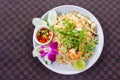 Fried rice with shrimp on the white ceramic dish decorated with orchid and hot spicy dipping sauce put on leather floor the grid Royalty Free Stock Photo