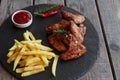 Fried roasted chicken wings french fries and sauce