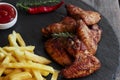 Fried roasted chicken wings french fries and sauce