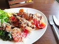 Fried roasted shrimps in plate with lemon and green salat