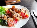 Fried roasted shrimps in plate with lemon and green salat