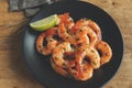 Fried roasted shrimps in plate with lemon greens parsley garlic Royalty Free Stock Photo