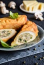 Fried rolls coated in batter and stuffed with mushroom, cheese, onion and parsley