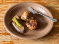 Fried russian Kotleta, bread and pickled cucumber