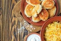 Fried russian pastry pirozhki on wooden background.