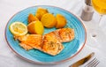 Fried salmon fillet with boiled potatoes in skins Royalty Free Stock Photo