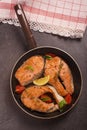 Fried salmon in pan with lemonq tomatto and aromatic herbs Royalty Free Stock Photo