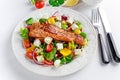 Fried Salmon steak with fresh vegetables salad, feta cheese. concept healthy food. Royalty Free Stock Photo