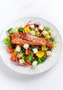 Fried Salmon steak with fresh vegetables salad, feta cheese. concept healthy food. Royalty Free Stock Photo